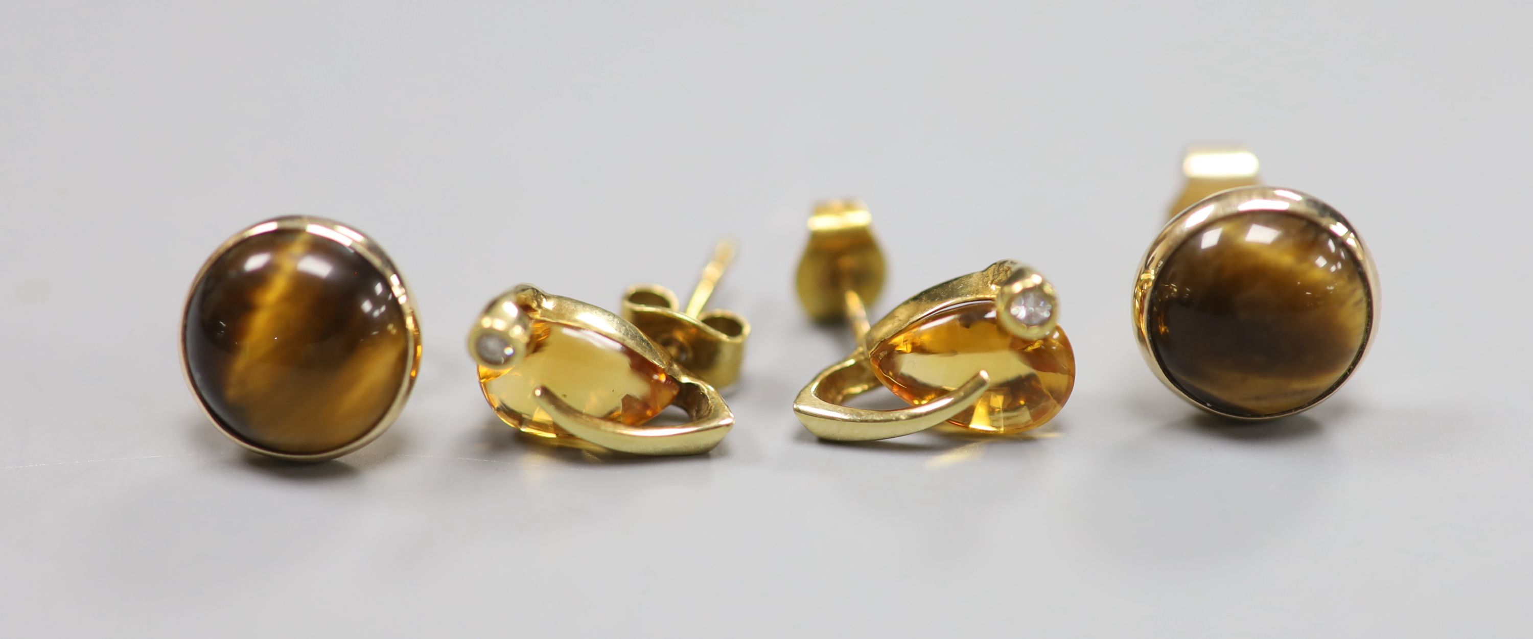 Two modern pairs of 9ct gold and gem set earstuds, tigers eye quartz and citrine and diamond, gross 4.7 grams.